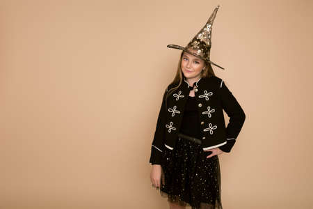 Beautiful young girl in halloween outfit in the studio.