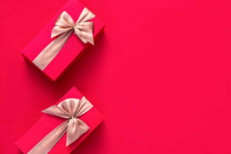 Christmas red background with Christmas gifts decor. Top view with copy space. Minimalism. Merry Christmas.の写真素材