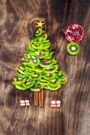 Christmas Tree made of food on wooden background. Top view. Flat lay. Christmas and New Year Holidays conceptの写真素材
