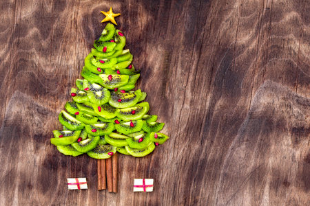 Christmas Tree made of food on wooden background. Top view. Flat lay. Christmas and New Year Holidays conceptの写真素材