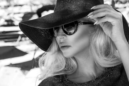 Fashion model in elegant hat and sunglasses in Cannes France. Stylish woman in Cannes. Marina,...