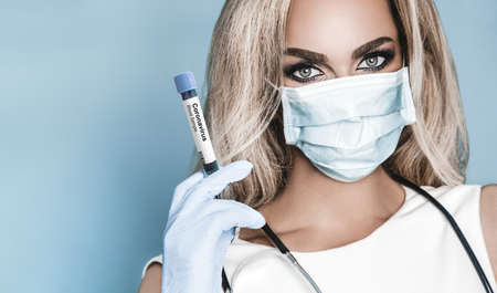 Stop the infection! Anti smog and viruses. Close up portrait of a young woman with medicine healthcare mask on background in studio.の写真素材