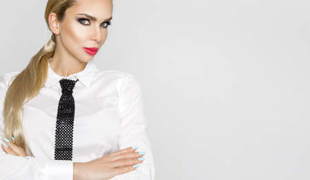 Elegant sexy business woman dressed in white shirt and tie and glasses. Sensual businesswoman with glasses. Portrait of Urban Business woman wearing tie.の写真素材