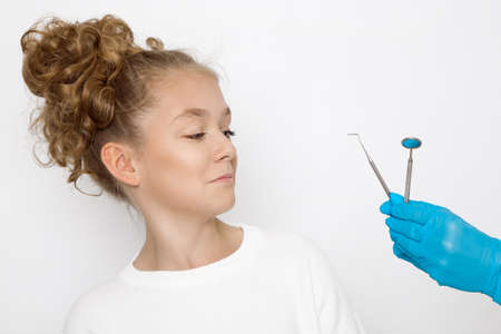Little girl in dental clinic, patient visit for treatment or orthodont correction. Dental treatment, orthodont medicine for kids and teens. Kid in the dentist.の写真素材
