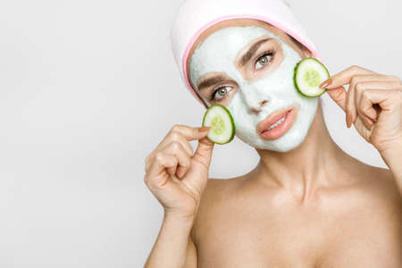 Beautiful blonde woman with moisturized face mask. Beauty spa. Skincare concept. Woman with facial mask.の写真素材