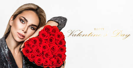 Valentine elegant girl with red heart isolated on white background. Beautiful Happy Young woman with heart of roses. Holiday party, birthday. Valentine's day- concept.の写真素材