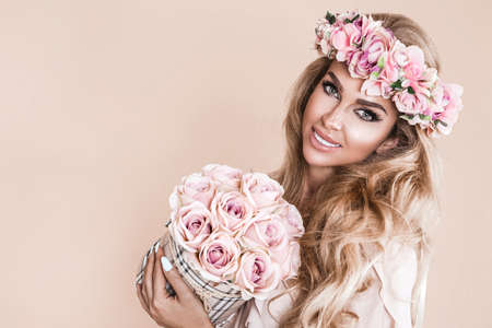 Spring concept. Beautiful natural woman in wreath with flowers. Spring makeup girl portrait. Beauty portrait of female face with natural skin. Spring fashion photo. Skin care concept, beauty spa, bio product.の写真素材