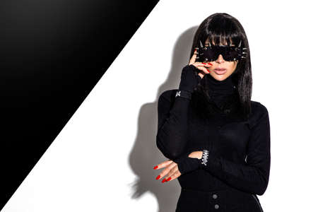 High fashion look. Glamor stylish beautiful young model in black clothing isolated on white...