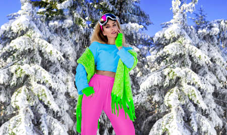 Young woman winter portrait. Winter fashion model with ski suit and goggles. Attractive young woman...