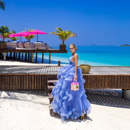 Summer fashion. Elegant fashion model. Glamor, stylish sexy blonde female model in elegant long wedding dress on the Maldives beach. Travel model. Elegance. Bride on Maldives. Bridal. Vogue.の写真素材