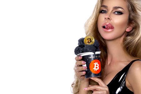 Beautiful girl with bitcoin ice cream. Bitcoin cryptocurrency. Sexy woman with bitcoin isolated on white background. Bull market. Sexy girl licks ice cream.の写真素材