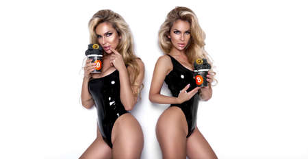 Beautiful girl with bitcoin ice cream. Bitcoin cryptocurrency. Sexy woman with bitcoin isolated on white background. Bull market. Sexy girl licks ice cream.の写真素材
