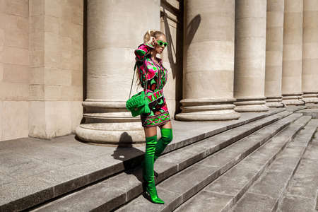 Spring, summer fashion. High fashion model. Glamor, stylish elegant woman. female model in colorful dress in the city. Travel model. Outdoor shoot. Casual, urban style. Vogue.の写真素材