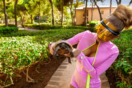 Beautiful woman hold big turtle on Praslin island on Seychelles.の写真素材