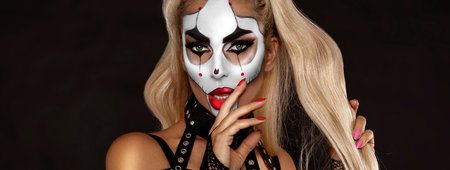 Sexy woman in a Halloween makeup on black background.の写真素材