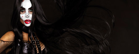 Sexy woman in a Halloween makeup on black background.の写真素材
