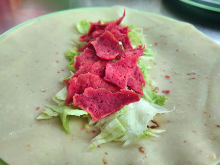 Kebab food stuffing consists of meat, sauce, vegetables, kebab flour skin, on a plate. In banten, indonesiaの写真素材