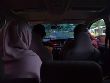 Photo of a family atmosphere in the car while on a trip with a highway backgroundの写真素材