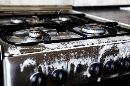 Dirty gas stove filled with detergent. Cleansing, foaming, cleaning, grease remover. Photo, macro photographyの写真素材