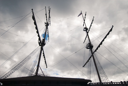 sailing ship masts and gunter silhouette at stormy sky