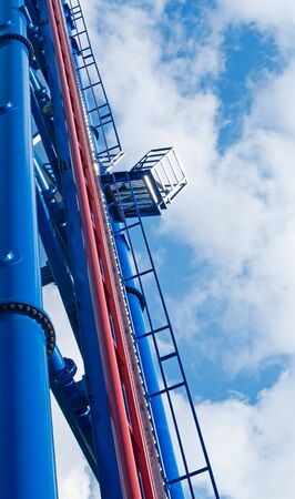 Top platform at the huge thrill ride at blue cloudy sky