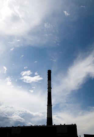 Big chimney silhouette at the fantastic cloudy skyの写真素材