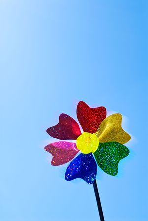 Rotated pinwheel (wind-toy) at clear blue skyの写真素材