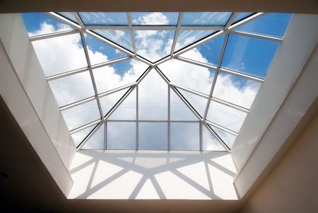 Cloudy sky captured by the  glass roof of modern buildingの写真素材