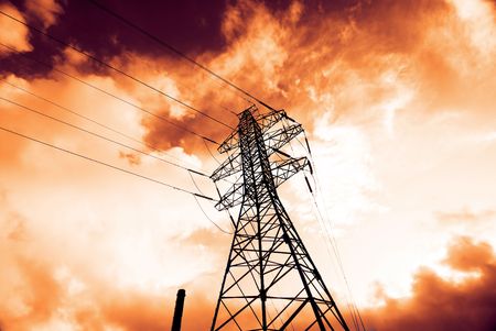 Power line carrier tower over bright sunset skyの写真素材