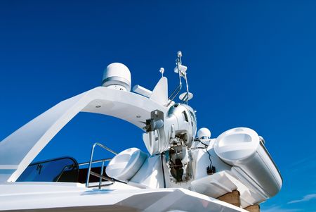 Top of modern yacht with motor-boat over blue skyの写真素材