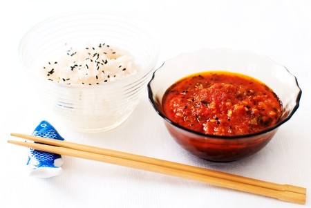Colorful asian meal - sesame rice, tomato chutney and chopsticksの写真素材