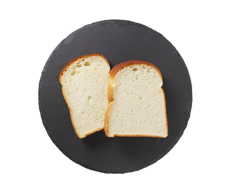 Slice of white bread isolated on whiteの写真素材