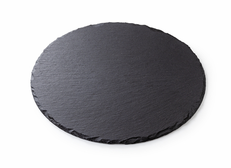 Black round stone plate with white backgroundの写真素材