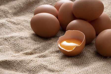 Eggs on the burlap and broken eggs are photographed from an angle