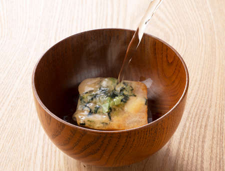 Pour hot water into a bowl of freeze-dried miso soup.の写真素材