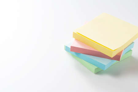 Four colorful sticky notes in four colors on a white background with plenty of space