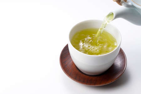 Pouring green tea into a teacup. Japanese green tea imageの写真素材