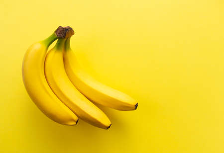 Bananas on a yellow background with a copy spaceの写真素材