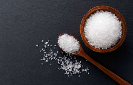Himalayan rock salt placed on a black background with space. A view from aboveの写真素材