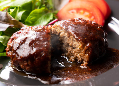 Cross section of hamburger with demi-glace sauce cut in halfの写真素材