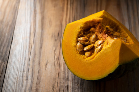 Quartered pumpkin on a wooden backgroundの写真素材