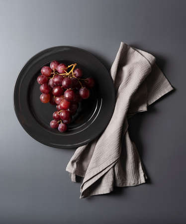 Red Globe served on a plate set against a gray background. View from directly above.の写真素材