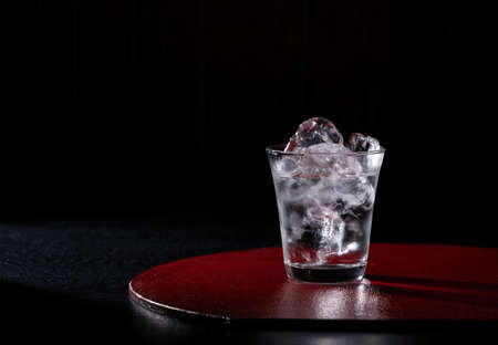 Shochu on a red tray on a black background with copy space. The image of Japanese liquor.の写真素材