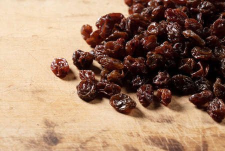 Raisins on the old wooden background with a copy space.の写真素材