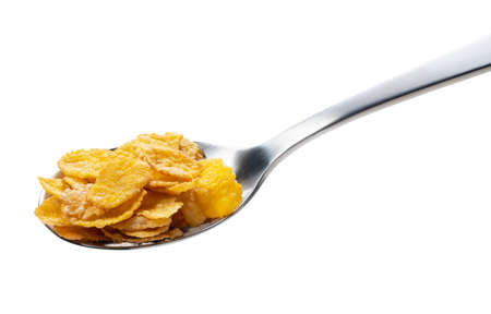 Corn flakes on the spoon isolated on whiteの写真素材