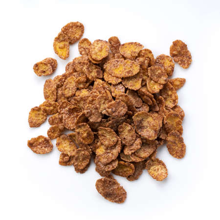 Chocolate cornflakes placed on a white background. View from directly above.