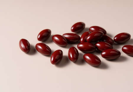 Brown pills on beige background. Concept of pharmaceuticals and supplements.の写真素材