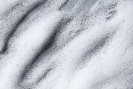 Bubbles texture background on gray background. Soap, shampoo, mousse, shower gel foam.の写真素材