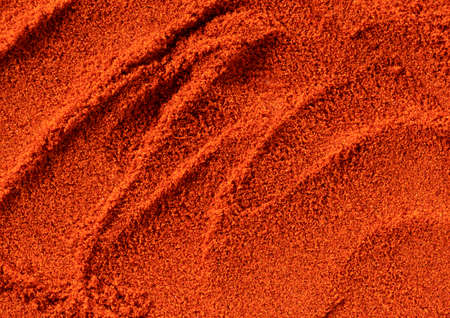 Red pepper powder all over the screen. Cayenne pepper. Paprika powder. View from above. Food backgroundの写真素材