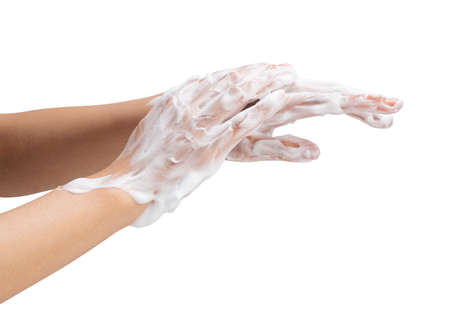 Female hand washing hands with soap lather on white background. Hands with white foam. Texture of...